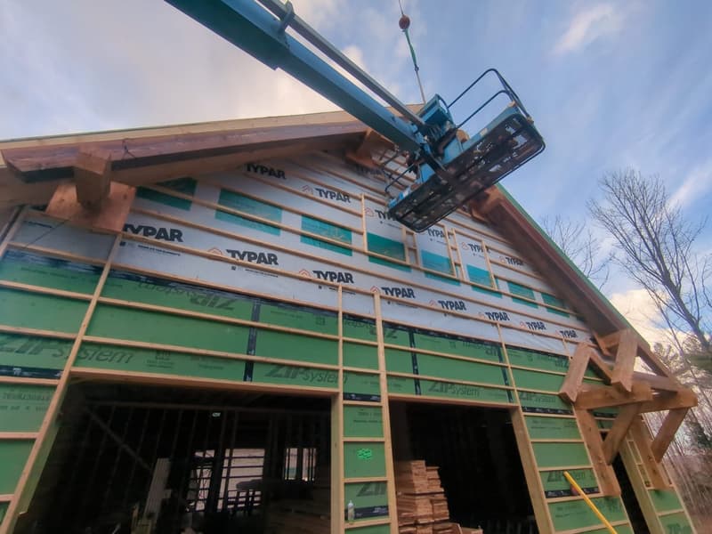 Timber frame barn with ZIP System sheathing and strapping during enclosure phase