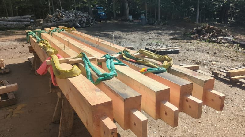 Pre-cut timber frame kit bundled for crane delivery to a job site