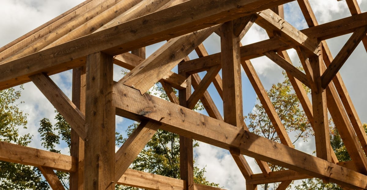 Queens post truss spanning a timber frame great room